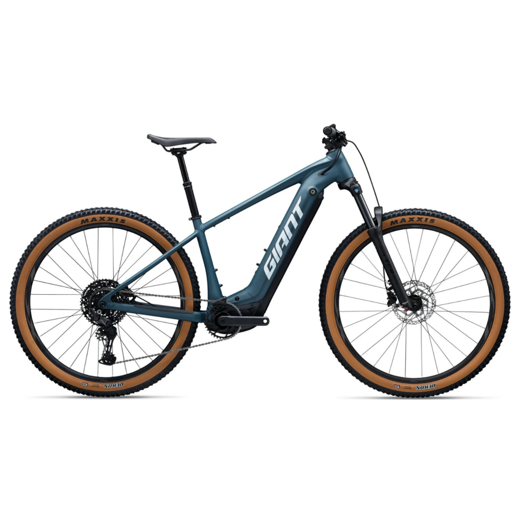 A deep metalic blue Giant Fathom E+ hardtail electric mountain bike side on